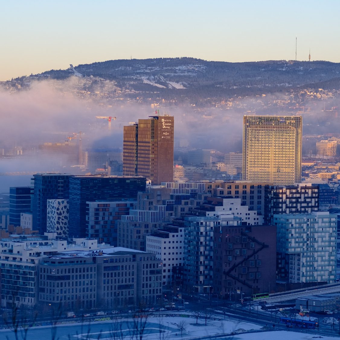 Panorama over Oslo med skyer og lavt sollys